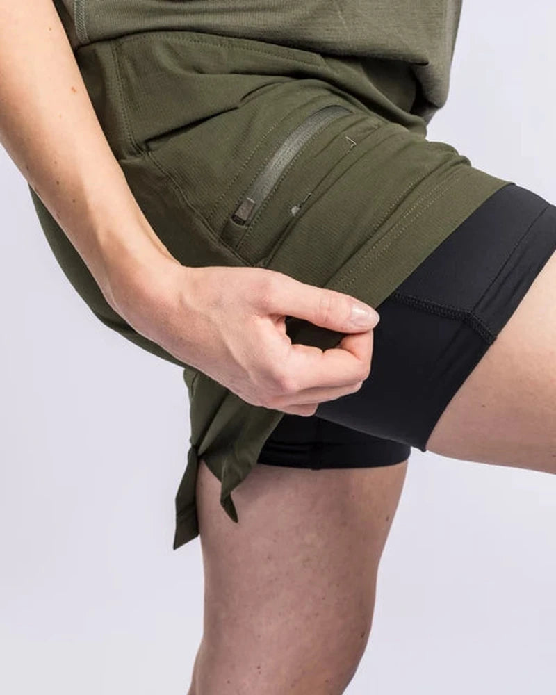 Mörkgrönt skort med inbyggda svarta shorts i närbild
