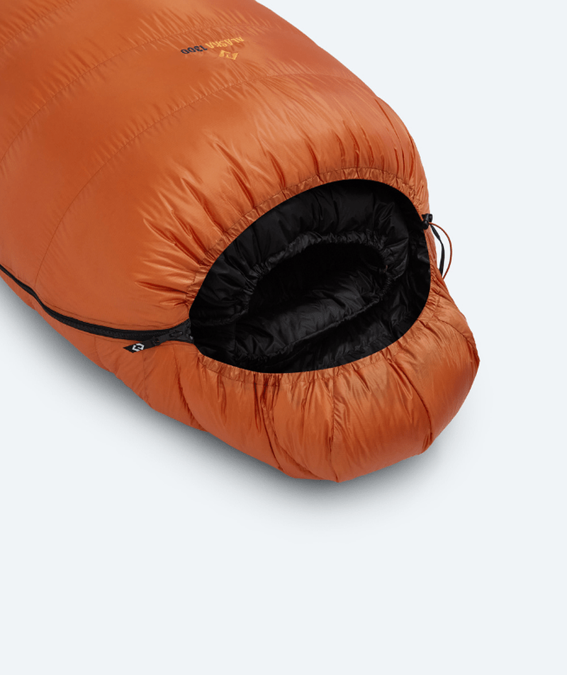Närm vy av dragkedja och huvmunnen på orange Cumulus vintersovsäck