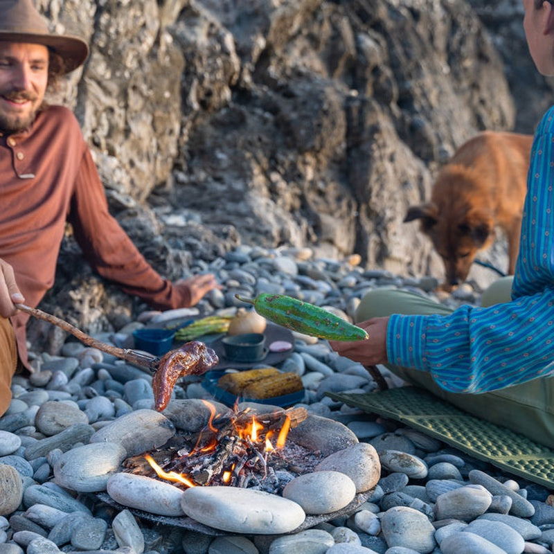 Grillning av korv och paprika med FireFork på stenig strand